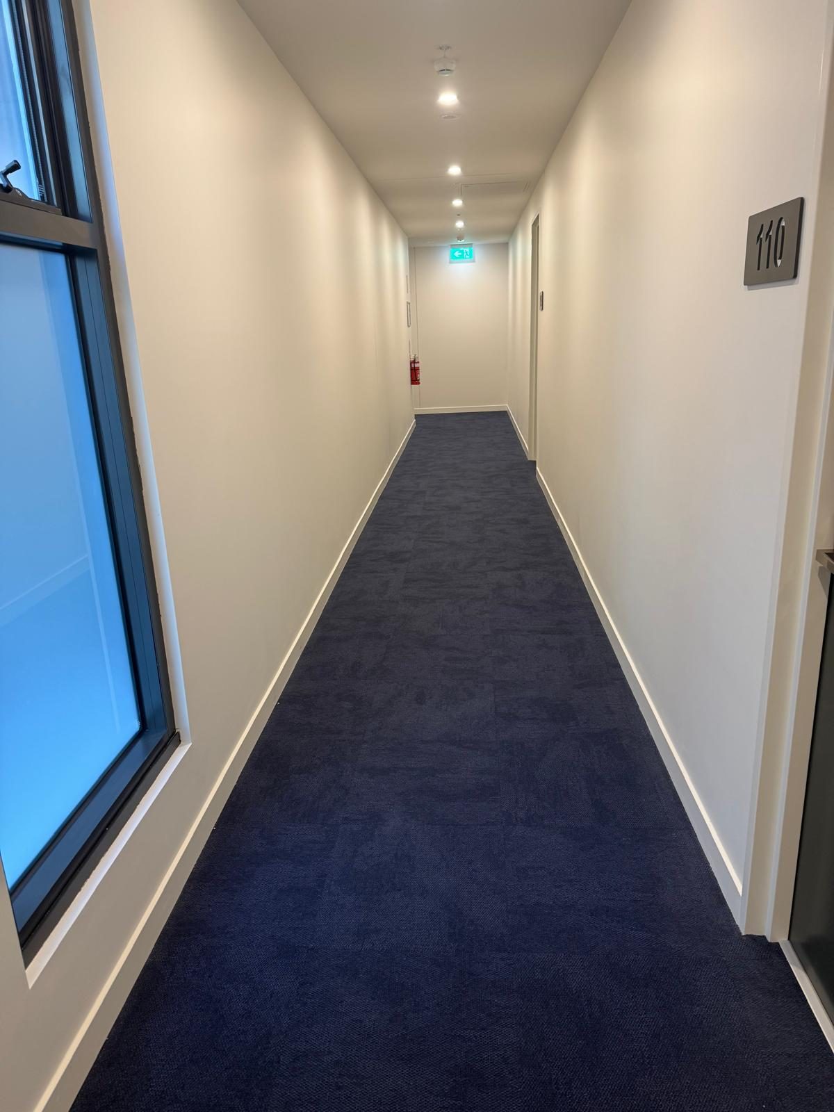 Residential corridor with freshly cleaned carpet and skirtings